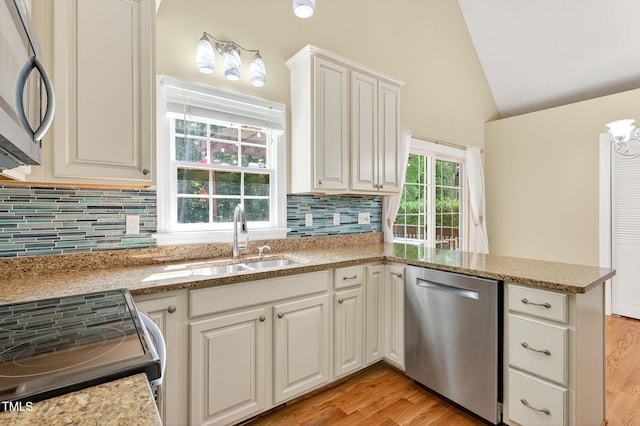 116 Seminole Dr, Louisburg, NC 27549 - kitchen with appliances with stainless steel finishes, vaulted ceiling, healthy amount of natural light, and tasteful backsplash