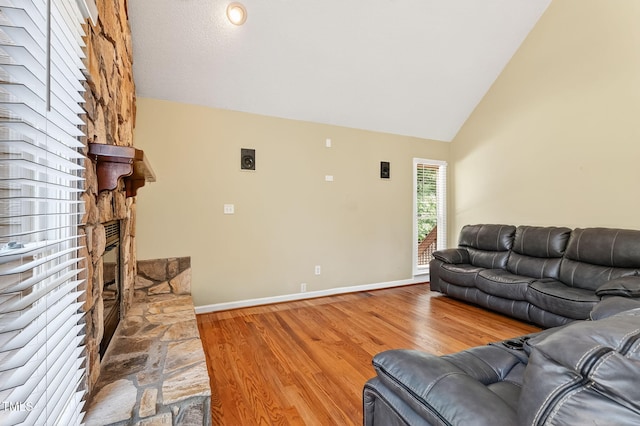 116 Seminole Dr, Louisburg, NC 27549 - living room with wood finished floors, a stone fireplace, and high vaulted ceiling