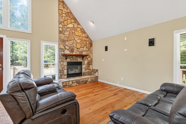 116 Seminole Dr, Louisburg, NC 27549 - living room with wood finished floors, high vaulted ceiling, and a stone fireplace