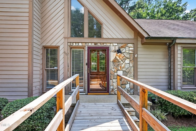 116 Seminole Dr, Louisburg, NC 27549 - view of exterior entry with a shingled roof and stone siding
