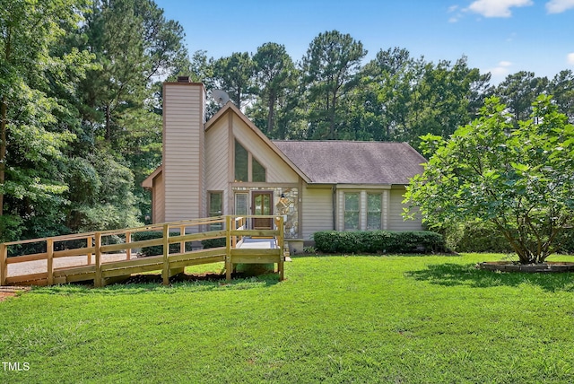 116 Seminole Dr, Louisburg, NC 27549 - rear view of property featuring a lawn, a chimney, a wooden deck, and roof with shingles