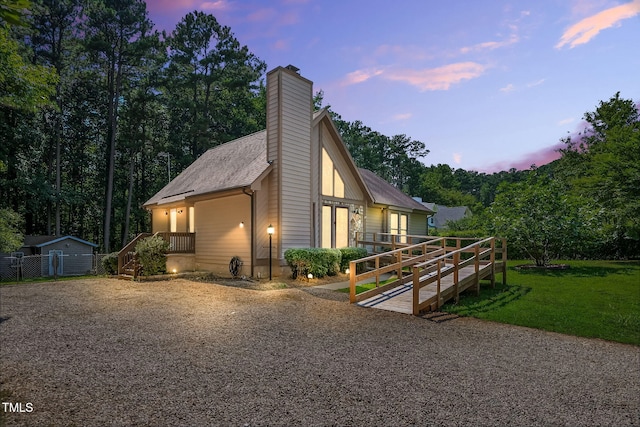 116 Seminole Dr, Louisburg, NC 27549 - property exterior at dusk featuring a chimney and a lawn