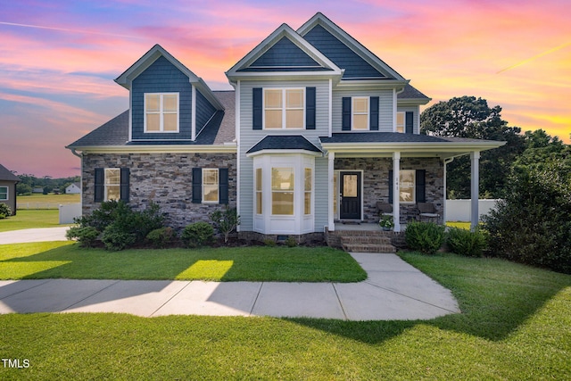141 Vibernum Vw, Four Oaks, NC 27524 - craftsman-style home featuring covered porch, a lawn, and stone siding