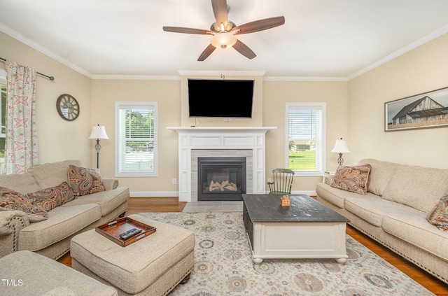 141 Vibernum Vw, Four Oaks, NC 27524 - living room featuring light wood-style floors, healthy amount of natural light, ornamental molding, a ceiling fan, and a fireplace