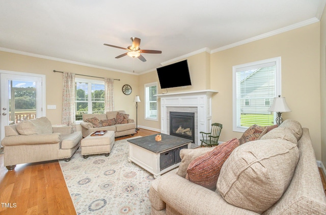 141 Vibernum Vw, Four Oaks, NC 27524 - living area with wood finished floors, a ceiling fan, crown molding, and a high end fireplace