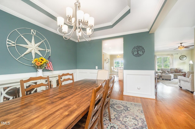 141 Vibernum Vw, Four Oaks, NC 27524 - dining space featuring wood finished floors, a wainscoted wall, crown molding, a chandelier, and a ceiling fan