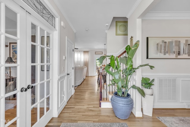 126 Gwendolyn Way, Fuquay Varina, NC 27526 - hallway with french doors, light wood-type flooring, and ornamental molding