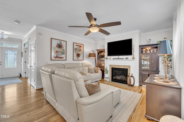 126 Gwendolyn Way, Fuquay Varina, NC 27526 - living area featuring a ceiling fan, light wood-type flooring, ornamental molding, and a fireplace with flush hearth