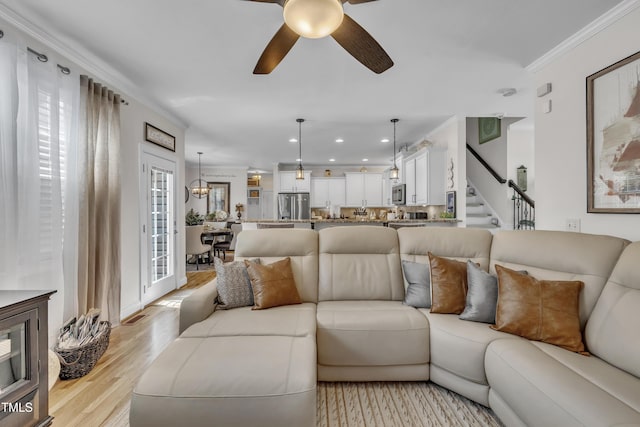 126 Gwendolyn Way, Fuquay Varina, NC 27526 - living room with ornamental molding, light wood-style flooring, ceiling fan, stairs, and recessed lighting