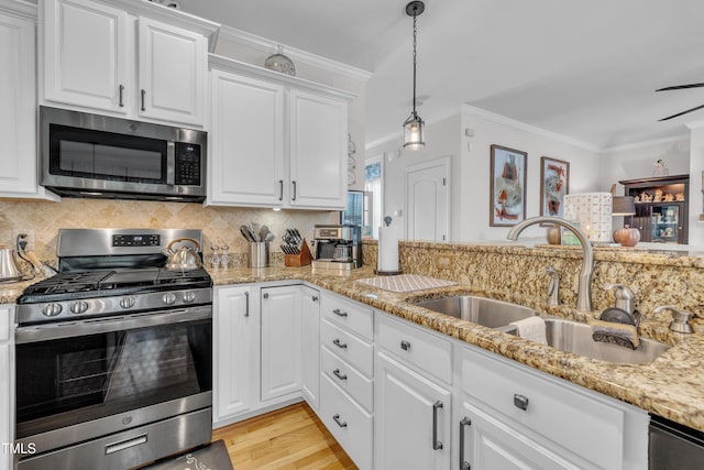 126 Gwendolyn Way, Fuquay Varina, NC 27526 - kitchen featuring stainless steel appliances, white cabinetry, decorative backsplash, light stone countertops, and light wood-style floors