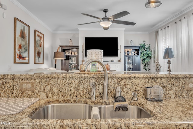 126 Gwendolyn Way, Fuquay Varina, NC 27526 - kitchen featuring ceiling fan, crown molding, light stone countertops, and open floor plan