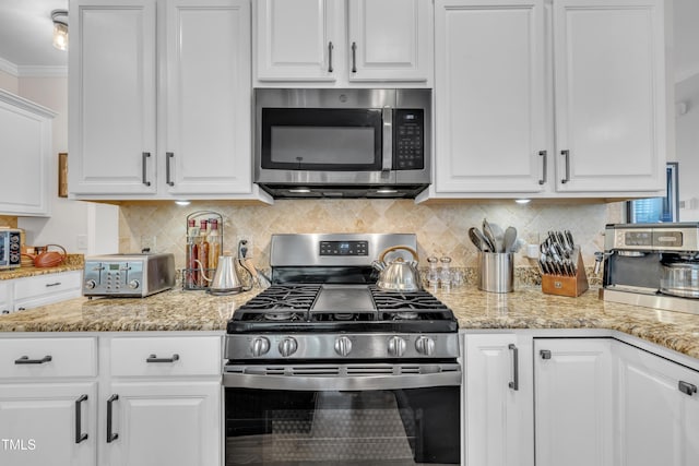 126 Gwendolyn Way, Fuquay Varina, NC 27526 - kitchen featuring stainless steel appliances, white cabinets, ornamental molding, and backsplash