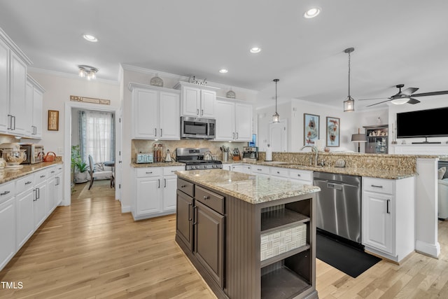 126 Gwendolyn Way, Fuquay Varina, NC 27526 - kitchen with appliances with stainless steel finishes, crown molding, a peninsula, white cabinetry, and recessed lighting