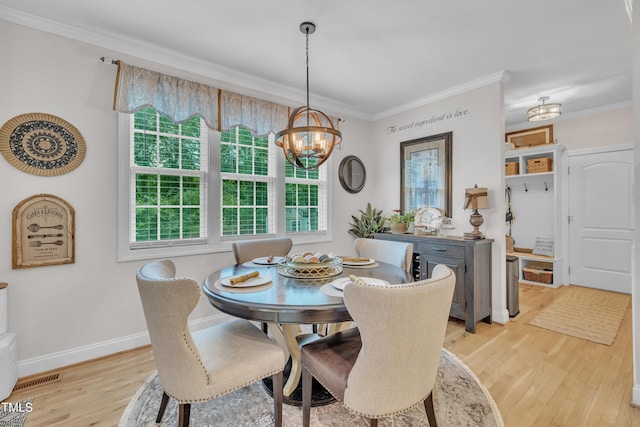 126 Gwendolyn Way, Fuquay Varina, NC 27526 - dining area with light wood-style floors, a chandelier, and crown molding
