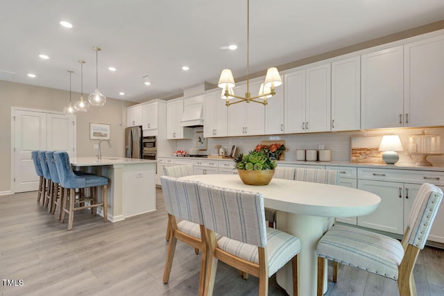 3010 Shady Sage Way Lot 15, Apex, NC 27523 - dining space featuring light wood-type flooring, recessed lighting, and a chandelier