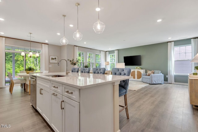 3010 Shady Sage Way Lot 15, Apex, NC 27523 - kitchen with plenty of natural light, recessed lighting, light wood-type flooring, white cabinets, and decorative light fixtures