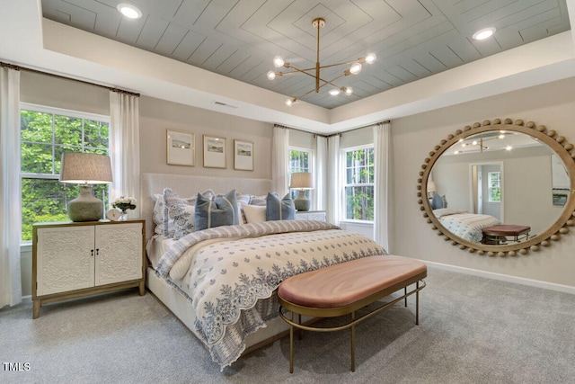 3010 Shady Sage Way Lot 15, Apex, NC 27523 - bedroom featuring multiple windows, light carpet, and a chandelier