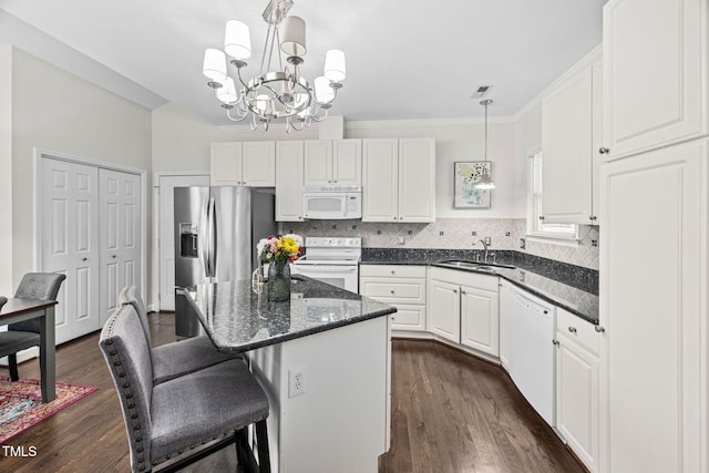 316 Boltstone Ct, Cary, NC 27513 - kitchen with white appliances, a chandelier, white cabinets, dark wood-style flooring, and crown molding
