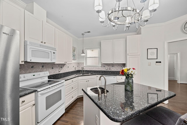 316 Boltstone Ct, Cary, NC 27513 - kitchen featuring white appliances, ornamental molding, dark wood-type flooring, decorative backsplash, and a chandelier