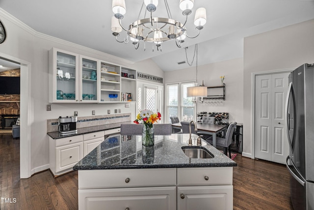 316 Boltstone Ct, Cary, NC 27513 - kitchen featuring freestanding refrigerator, vaulted ceiling, a chandelier, dark wood-style floors, and white cabinets
