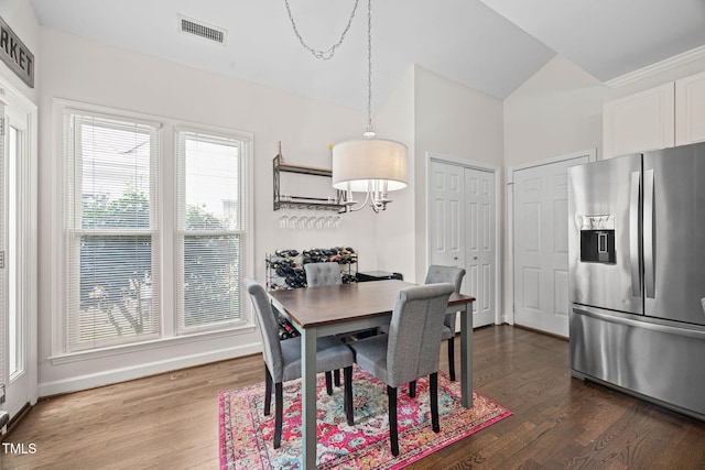 316 Boltstone Ct, Cary, NC 27513 - dining room featuring dark wood-style floors, lofted ceiling, and a chandelier