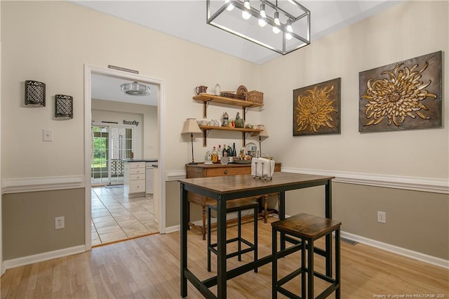 7655 Lucinda Ln, Linden, NC 28356 - dining area with light wood finished floors and a chandelier