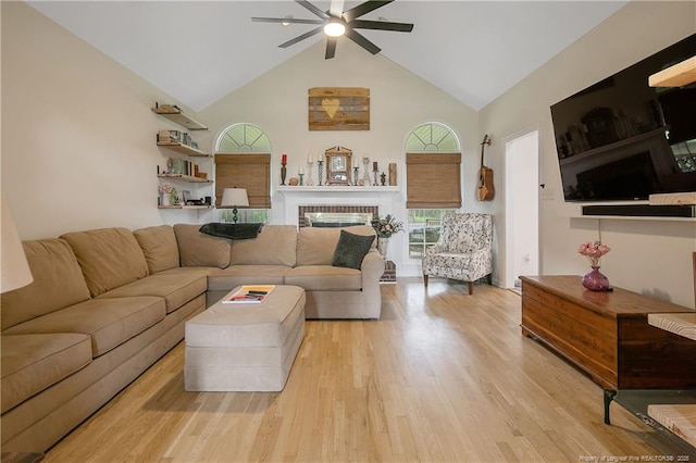 7655 Lucinda Ln, Linden, NC 28356 - living room with ceiling fan, high vaulted ceiling, light wood-style floors, and a fireplace