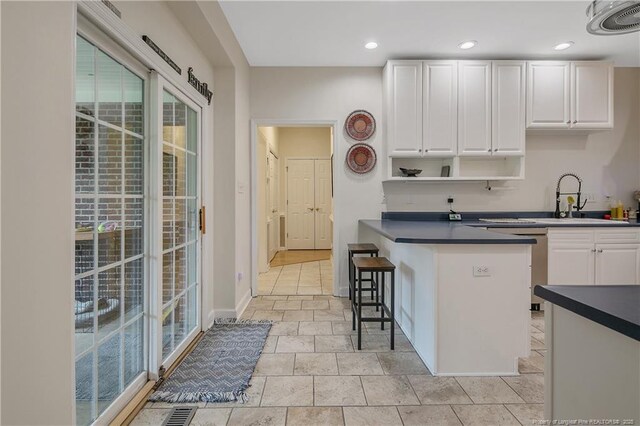 7655 Lucinda Ln, Linden, NC 28356 - kitchen featuring dark countertops, white cabinets, plenty of natural light, open shelves, and recessed lighting
