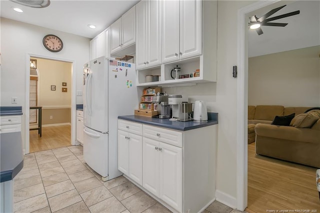 7655 Lucinda Ln, Linden, NC 28356 - kitchen with freestanding refrigerator, a ceiling fan, dark countertops, white cabinets, and open shelves