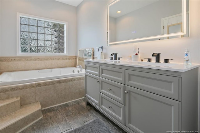 7655 Lucinda Ln, Linden, NC 28356 - bathroom featuring double vanity, a bath, and wood finished floors