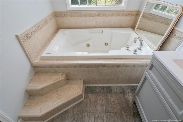 7655 Lucinda Ln, Linden, NC 28356 - bathroom featuring a jetted tub, vanity, and wood finished floors