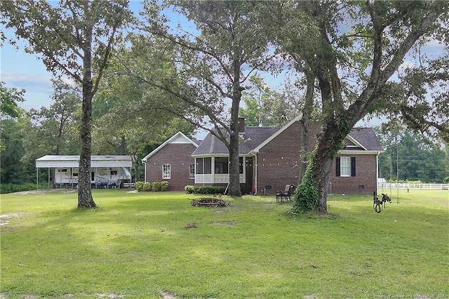 7655 Lucinda Ln, Linden, NC 28356 - rear view of house featuring a lawn, an outdoor fire pit, and brick siding