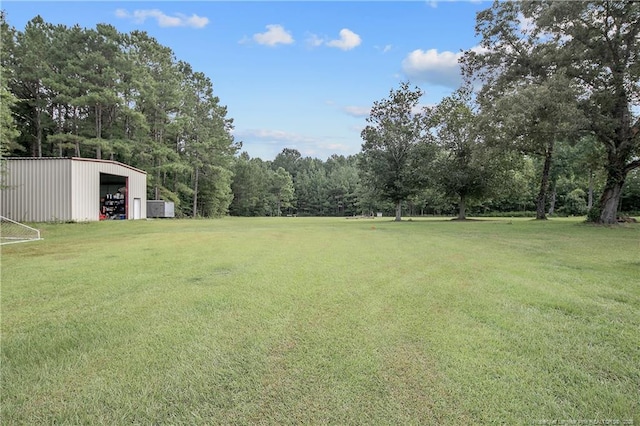 7655 Lucinda Ln, Linden, NC 28356 - view of green lawn featuring a pole building, an outdoor structure, and a detached garage
