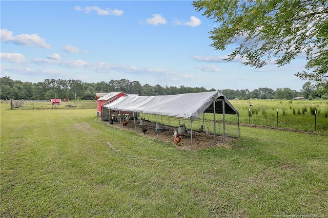 7655 Lucinda Ln, Linden, NC 28356 - view of green lawn with a view of rural / pastoral area, exterior structure, a detached carport, and an outdoor structure