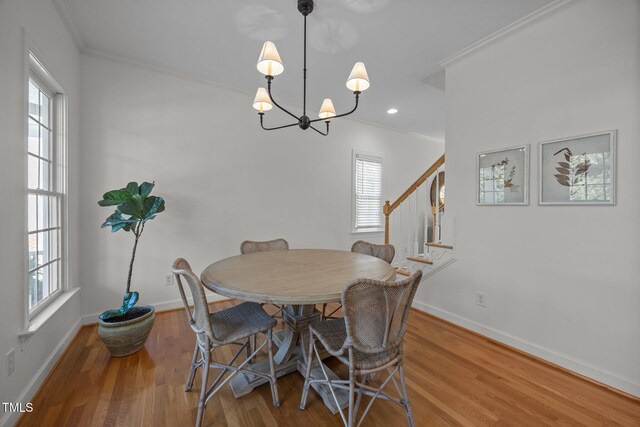 513 Moultonboro Ave, Wake Forest, NC 27587 - dining area featuring crown molding, wood finished floors, healthy amount of natural light, stairs, and recessed lighting