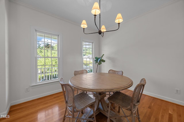 513 Moultonboro Ave, Wake Forest, NC 27587 - dining room with light wood finished floors, a chandelier, and crown molding