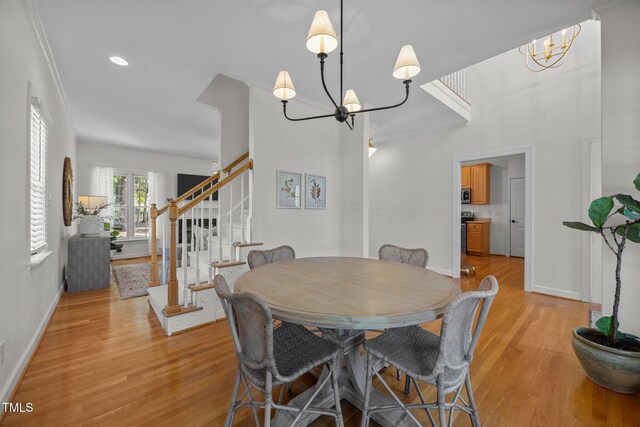 513 Moultonboro Ave, Wake Forest, NC 27587 - dining space featuring a chandelier, stairs, light wood-style flooring, recessed lighting, and ornamental molding