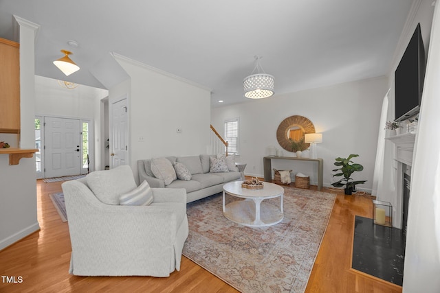 513 Moultonboro Ave, Wake Forest, NC 27587 - living area featuring healthy amount of natural light, light wood-style flooring, stairway, and crown molding