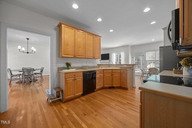 513 Moultonboro Ave, Wake Forest, NC 27587 - kitchen featuring dishwasher, a peninsula, light wood-style floors, light countertops, and a chandelier