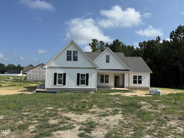 103 Spumante Ct, Princeton, NC 27569 - back of property featuring board and batten siding, a lawn, and roof with shingles