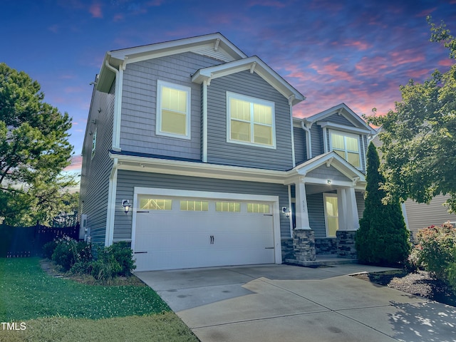 505 Poplar St, Durham, NC 27703 - view of front of house with an attached garage, driveway, a porch, and stone siding