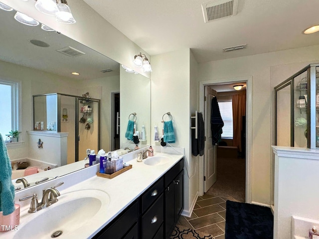 505 Poplar St, Durham, NC 27703 - bathroom featuring plenty of natural light, a shower stall, double vanity, and tile patterned flooring