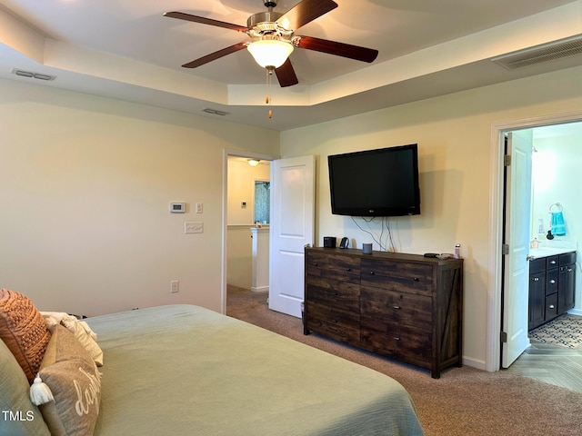 505 Poplar St, Durham, NC 27703 - bedroom with carpet floors, a raised ceiling, connected bathroom, and a ceiling fan