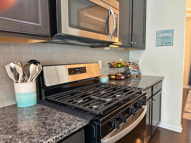 505 Poplar St, Durham, NC 27703 - kitchen with appliances with stainless steel finishes, decorative backsplash, dark stone counters, and dark wood-style flooring