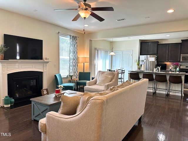 505 Poplar St, Durham, NC 27703 - living area with dark wood-style flooring, ceiling fan, a glass covered fireplace, and recessed lighting