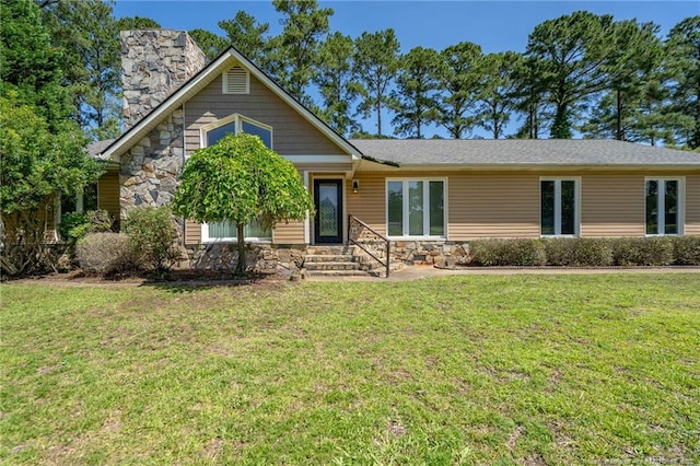 116 Bledsoe St, Hope Mills, NC 28348 - view of front of home featuring stone siding, a chimney, and a front lawn
