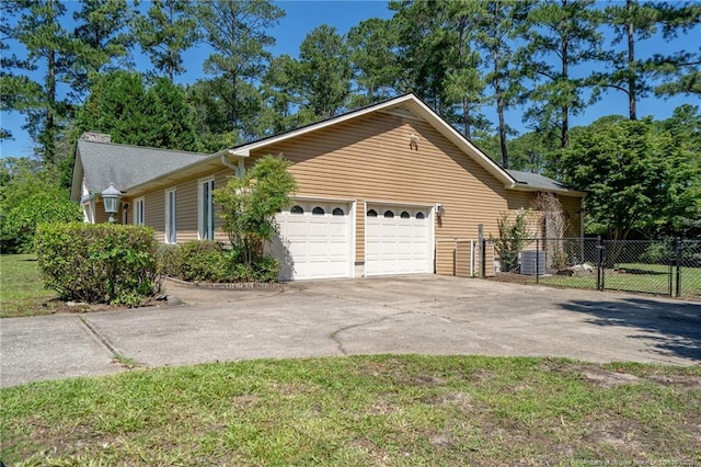 116 Bledsoe St, Hope Mills, NC 28348 - view of front facade featuring concrete driveway, an attached garage, and a chimney