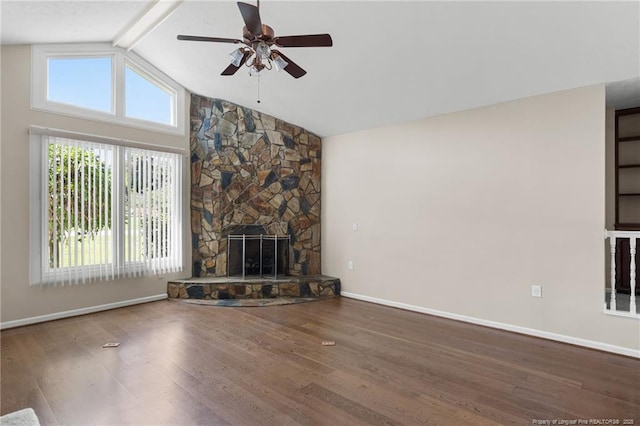 116 Bledsoe St, Hope Mills, NC 28348 - unfurnished living room featuring a ceiling fan, wood finished floors, beam ceiling, a stone fireplace, and high vaulted ceiling