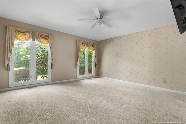 116 Bledsoe St, Hope Mills, NC 28348 - carpeted spare room with wallpapered walls and a ceiling fan