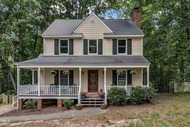 350 Amherst Creek Dr, Wake Forest, NC 27587 - view of front of house featuring a shingled roof, covered porch, and a chimney
